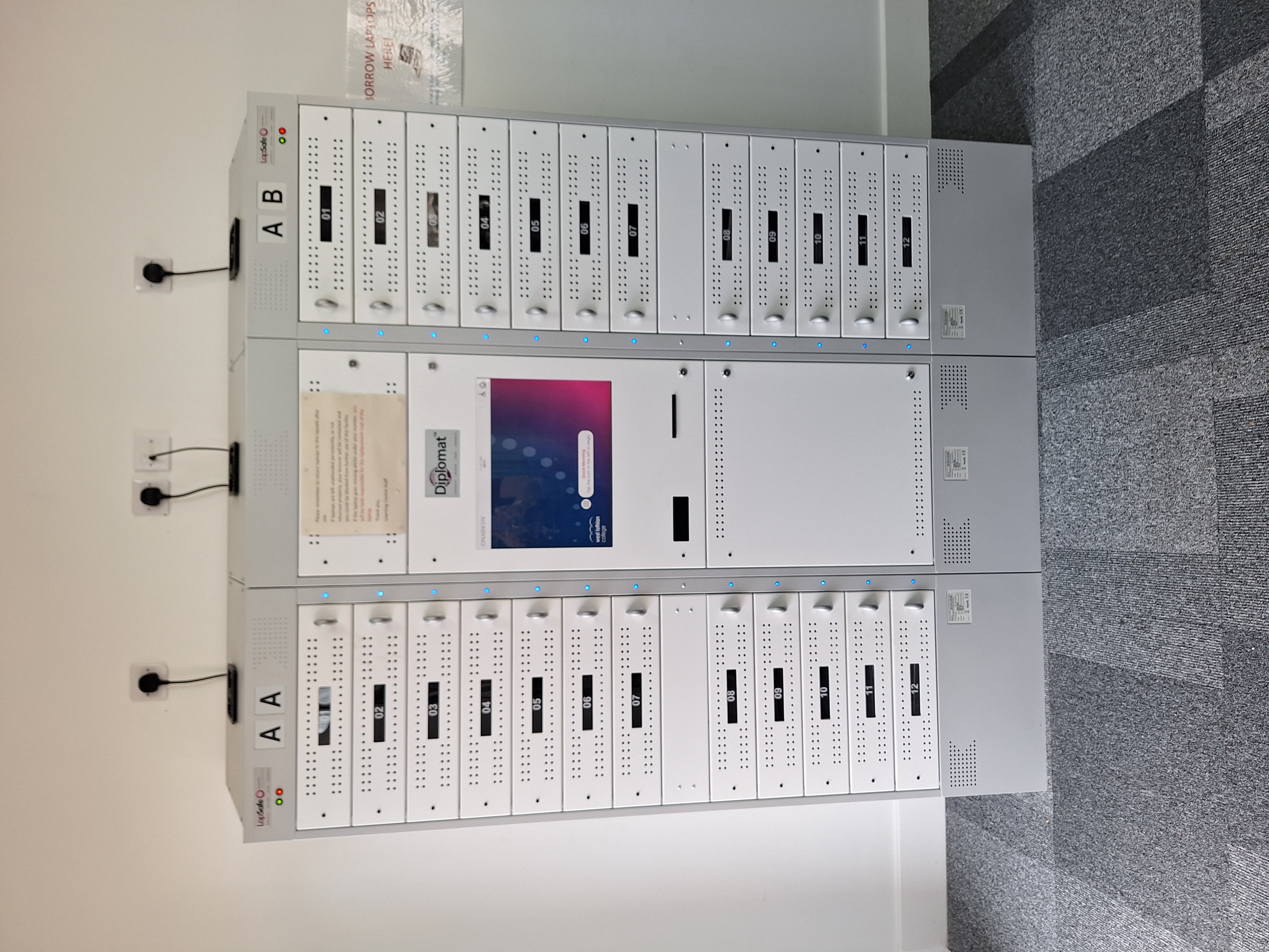 Image showing a large unit with 10 drawers either side and a touchscreen in the centre.